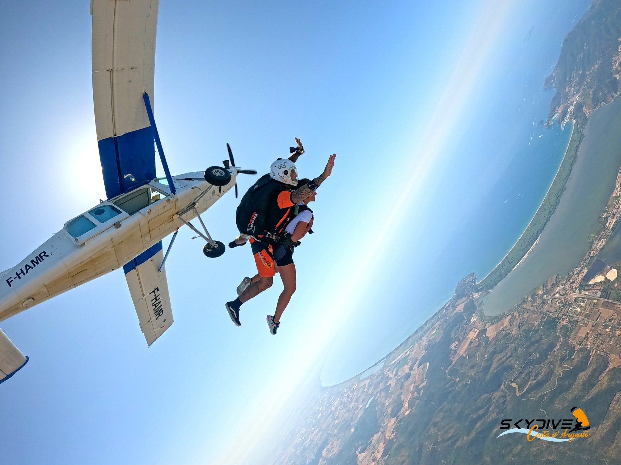 A tandem exit above the coastline